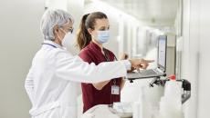 Healthcare professionals standing at a computer